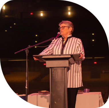 Peg Ruddy at the podium giving a speech